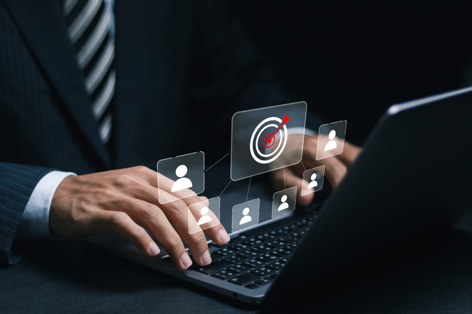 Customer relationship management concept. Businessman use laptop with target icon linked with human icons for customer focus group. Data exchanges development and customer service.